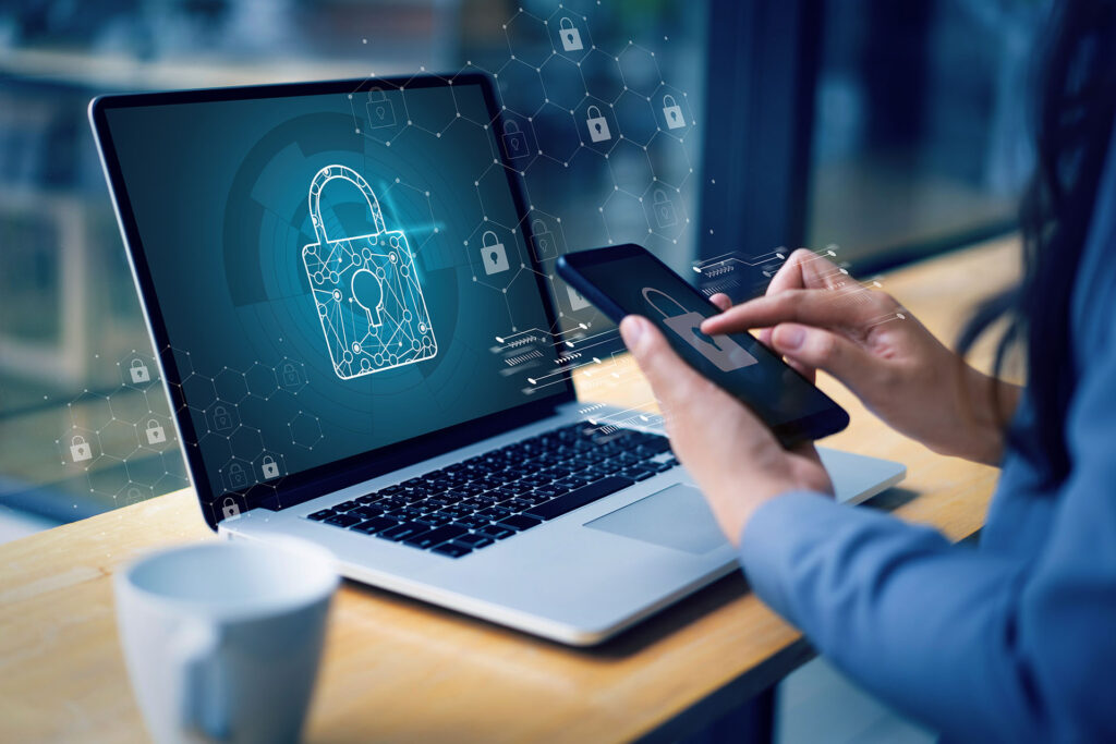 Woman with a laptop and mobile phone, both with secure padlock graphics overlaid